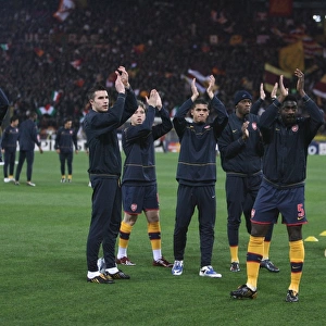 The Arsenal team wave to the fans before the match