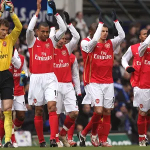 The Arsenal team wave to the fans before the match