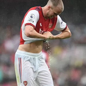Arsenal vs. Chelsea: Rob Holding Wrings Out Drenched Shirt Amidst Premier League Downpour (2021-22)