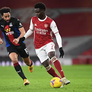 Arsenal vs Crystal Palace: Bukayo Saka in Action at Emirates Stadium Amidst Empty Seats (2020-21)