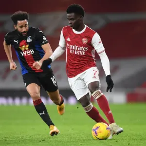 Arsenal vs Crystal Palace: Bukayo Saka in Action at Emirates Stadium Amidst Empty Seats (2020-21)