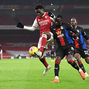 Arsenal vs. Crystal Palace: Bukayo Saka vs. Cheikhou Kouyate in Premier League Clash Amidst Empty Emirates Stadium