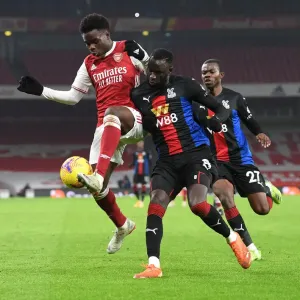 Arsenal vs. Crystal Palace: Bukayo Saka vs. Cheikhou Kouyate in Premier League Clash Amidst Empty Emirates Stadium