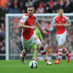 Arsenal vs. Liverpool: Aaron Ramsey's Intense Action in the 2014-15 Premier League Clash at Emirates Stadium