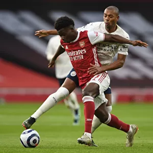 Arsenal vs Manchester City: Bukayo Saka Clashes with Fernandinho in Empty Emirates Stadium