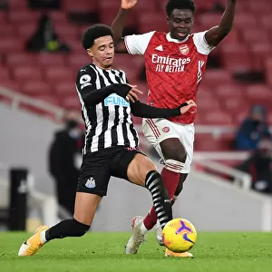 Arsenal vs Newcastle United: Bukayo Saka Tangles with Jamal Lewis in Empty Emirates Stadium