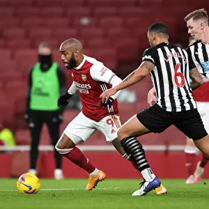 Arsenal vs Newcastle United: Lacazette Faces Off Against Lascelles and Krafth in Empty Emirates Stadium