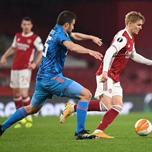Arsenal vs. Olympiacos: Martin Odegaard Clashes with Sokratis in Empty Europa League Match, London, 2021