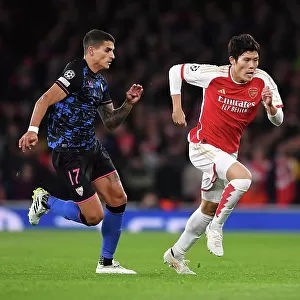 Arsenal vs Sevilla: Battle in Group B - Arsenal's Tomiyasu Outruns Lamela in the UEFA Champions League 2023/24