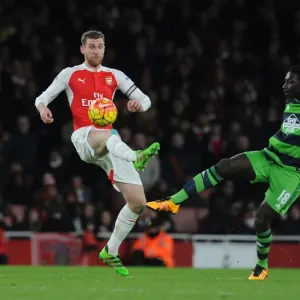 Arsenal vs Swansea Clash: Mertesacker vs Gomis Battle at Emirates Stadium