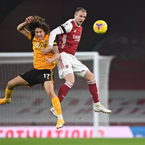 Arsenal vs. Wolverhampton Wanderers: Rob Holding's Heading Duel in Empty Emirates Stadium (Premier League 2020-21)