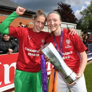 Arsenal Women Celebrate Historic WSL Title Win with Captains Sari van Veenendaal and Louise Quinn Holding the Trophy