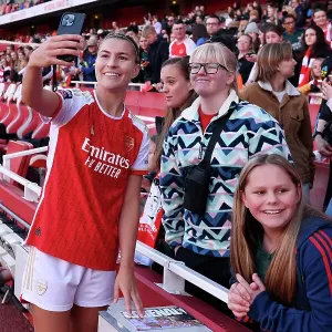 Arsenal Women's Team Celebrates Thrilling Victory over Aston Villa with Elated Fans at Emirates Stadium