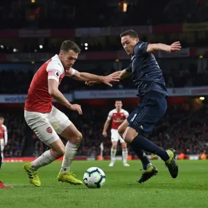 Arsenal's Aaron Ramsey Clashes with Manchester United's Luke Shaw and Nemanja Matic