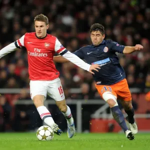 Arsenal's Aaron Ramsey Faces Off Against Montpellier's Marco Estrada in 2012-13 Champions League Clash