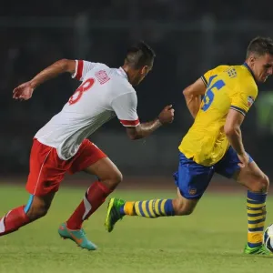 Arsenal's Aaron Ramsey Faces Off Against Raphael Maitimo of Indonesia Dream Team