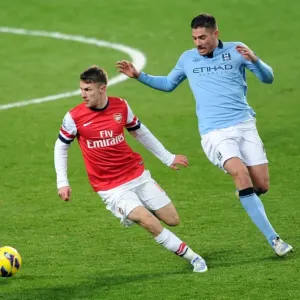 Arsenal's Aaron Ramsey Fends Off Manchester City's Javi Garcia in Intense Premier League Clash Arsenal's Aaron Ramsey Fends Off Manchester City's Javi Garcia in Intense Premier League Clash