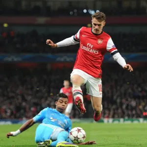 Arsenal's Aaron Ramsey Leaps Past Mario Lemina in Champions League Clash Arsenal's Aaron Ramsey Leaps Past Mario Lemina in Champions League Clash