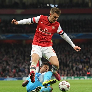 Arsenal's Aaron Ramsey Leaps Past Marseille's Mario Lemina in Champions League Clash