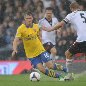 Arsenal's Aaron Ramsey Outmaneuvers Fulham's Brede Hangeland in Premier League Clash Arsenal's Aaron Ramsey Outmaneuvers Fulham's Brede Hangeland in Premier League Clash