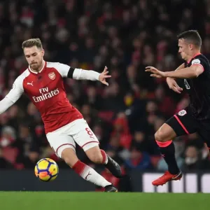 Arsenal's Aaron Ramsey Outmaneuvers Huddersfield's Jonathan Hogg in Premier League Clash Arsenal's Aaron Ramsey Outmaneuvers Huddersfield's Jonathan Hogg in Premier League Clash