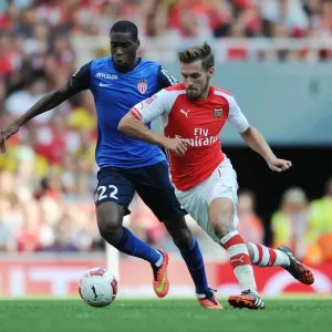 Arsenal's Aaron Ramsey Outmaneuvers AS Monaco's Geoffrey Kondogbia during the Emirates Cup Match