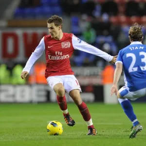 Arsenal's Aaron Ramsey Outmaneuvers Wigan's Ronnie Stam in Premier League Clash (December 2011)