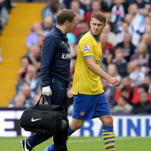 Arsenal's Aaron Ramsey Receives Treatment from Physio Colin Lewin during West Bromwich Albion Match