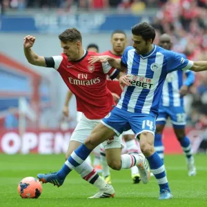 Arsenal's Aaron Ramsey vs. Wigan's Jordi Gomez: A FA Cup Semi-Final Battle Arsenal's Aaron Ramsey vs. Wigan's Jordi Gomez: A FA Cup Semi-Final Battle