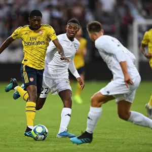 Arsenal's Ainsley Maitland-Niles Faces Off Against Jeff Reine-Adelaide in Angers Friendly