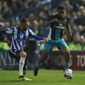 Arsenal's Alex Iwobi Clashes with Jack Hunt in Capital One Cup Battle