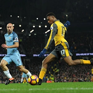 Arsenal's Alex Iwobi Faces Off Against Manchester City's Pablo Zabaleta in Premier League Showdown