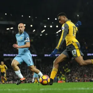 Arsenal's Alex Iwobi Faces Off Against Manchester City's Pablo Zabaleta in Premier League Showdown
