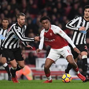 Arsenal's Alex Iwobi Faces Off Against Newcastle's Mikel Merino and Florian Lejeune