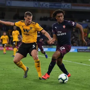 Arsenal's Alex Iwobi Fends Off Wolves Ryan Bennett During Intense Premier League Clash (Wolverhampton Wanderers vs Arsenal, 2018-19) Arsenal's Alex Iwobi Fends Off Wolves Ryan Bennett During Intense Premier League Clash (Wolverhampton Wanderers vs Arsenal, 2018-19)
