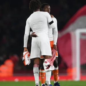 Arsenal's Alex Iwobi and Marc Bola of Blackpool Exchange Shirts After Carabao Cup Match