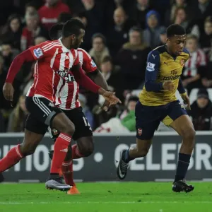 Arsenal's Alex Iwobi vs. Southampton's Cuco Martina: Intense Clash in Premier League Match (December 2015)