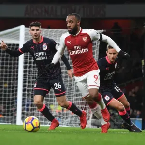 Arsenal's Alex Lacazette Clashes with Huddersfield's Schindler and Lowe Arsenal's Alex Lacazette Clashes with Huddersfield's Schindler and Lowe