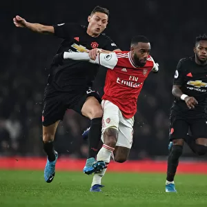 Arsenal's Alex Lacazette Outmaneuvers Manchester United's Matic and Fred during the 2019-20 Premier League Clash