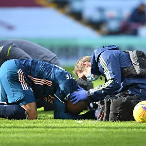 Arsenal's Alex Lacazette Receives Treatment from Physio in Empty Villa Park - Premier League 2021