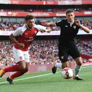 Arsenal's Alex Oxlade-Chamberlain Faces Off Against Sevilla's Sebastien Corchia at the Emirates Cup