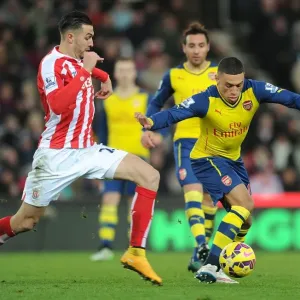 Arsenal's Alex Oxlade-Chamberlain Fends Off Stoke's Erik Pieters during Premier League Clash Arsenal's Alex Oxlade-Chamberlain Fends Off Stoke's Erik Pieters during Premier League Clash