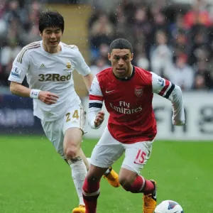 Arsenal's Alex Oxlade-Chamberlain Outmaneuvers Ki Sung-Yueng of Swansea Arsenal's Alex Oxlade-Chamberlain Outmaneuvers Ki Sung-Yueng of Swansea
