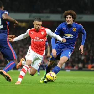 Arsenal's Alex Oxlade-Chamberlain Outmaneuvers Manchester United's Tyler Blackett and Marouane Fellaini Arsenal's Alex Oxlade-Chamberlain Outmaneuvers Manchester United's Tyler Blackett and Marouane Fellaini