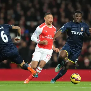 Arsenal's Alex Oxlade-Chamberlain Outmaneuvers Southampton's Jose Fonte and Victor Wanyama