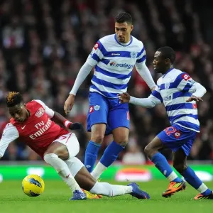 Arsenal's Alex Song Breaks Through QPR Defenders During Premier League Clash