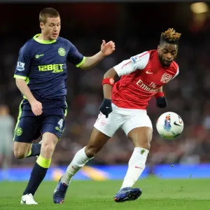 Arsenal's Alex Song Evades Wigan's James McCarthy Pressure in Premier League Clash