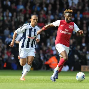 Arsenal's Alex Song Outmaneuvers West Brom's Peter Odemwingie in 2011-12 Premier League Clash Arsenal's Alex Song Outmaneuvers West Brom's Peter Odemwingie in 2011-12 Premier League Clash