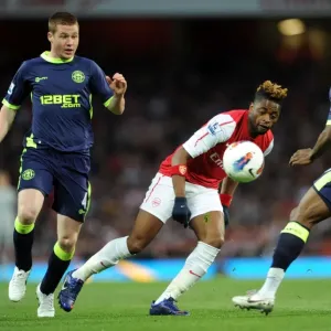 Arsenal's Alex Song Outmaneuvers Wigan's McCarthy and Figueroa