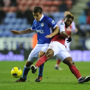 Arsenal's Alex Song Tackles Wigan's Franco Di Santo in Premier League Clash